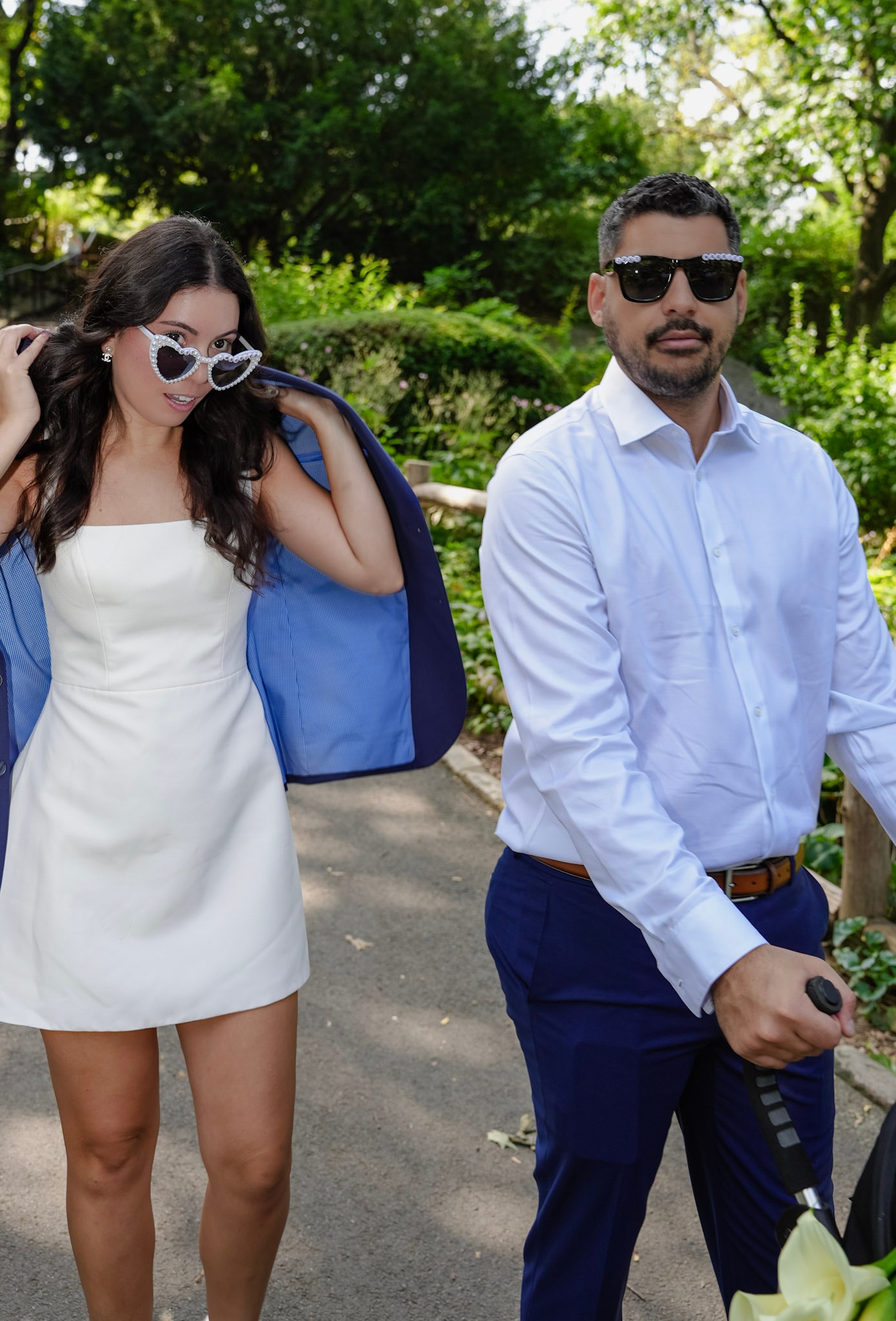 BeniCelo wedding - couple walking through Central Park in heart sunglasses